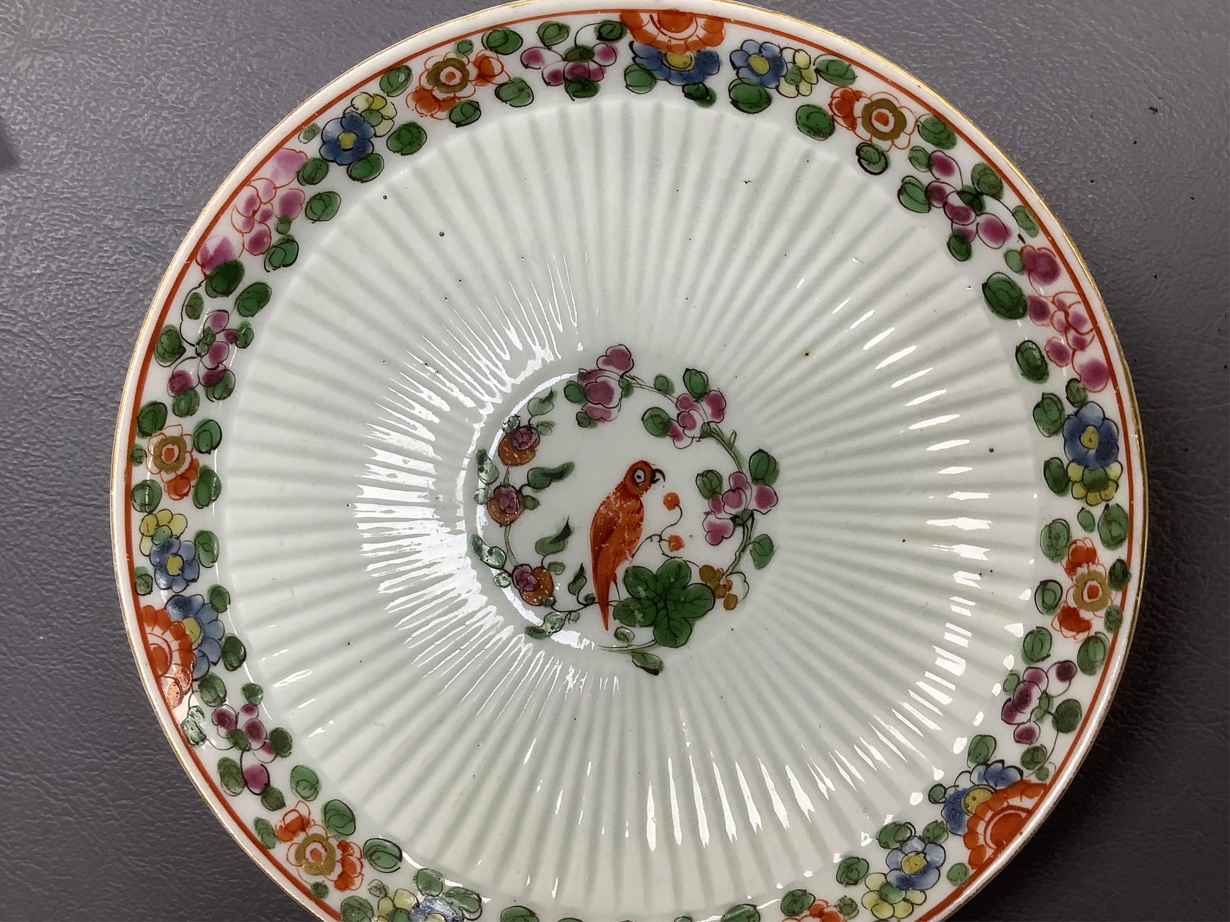A Worcester Old Worcester Parrot pattern tea bowl and saucer, c.1765-68, saucer 11.5cm in diameter